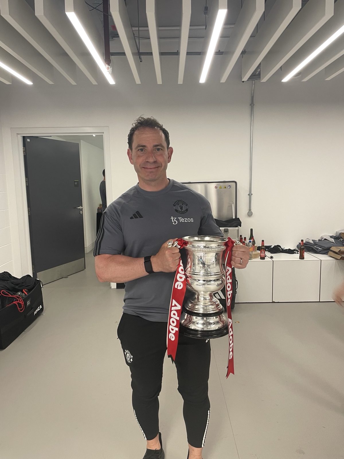 Al Stewart holding the Women's FA Cup with Manchester United
