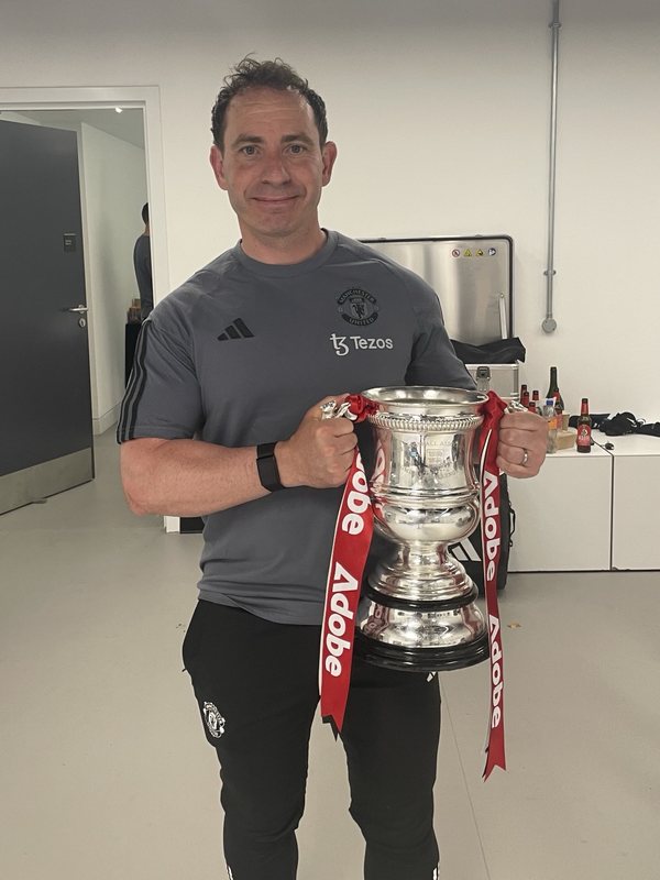Al Stewart holding the Women's FA Cup with Manchester United